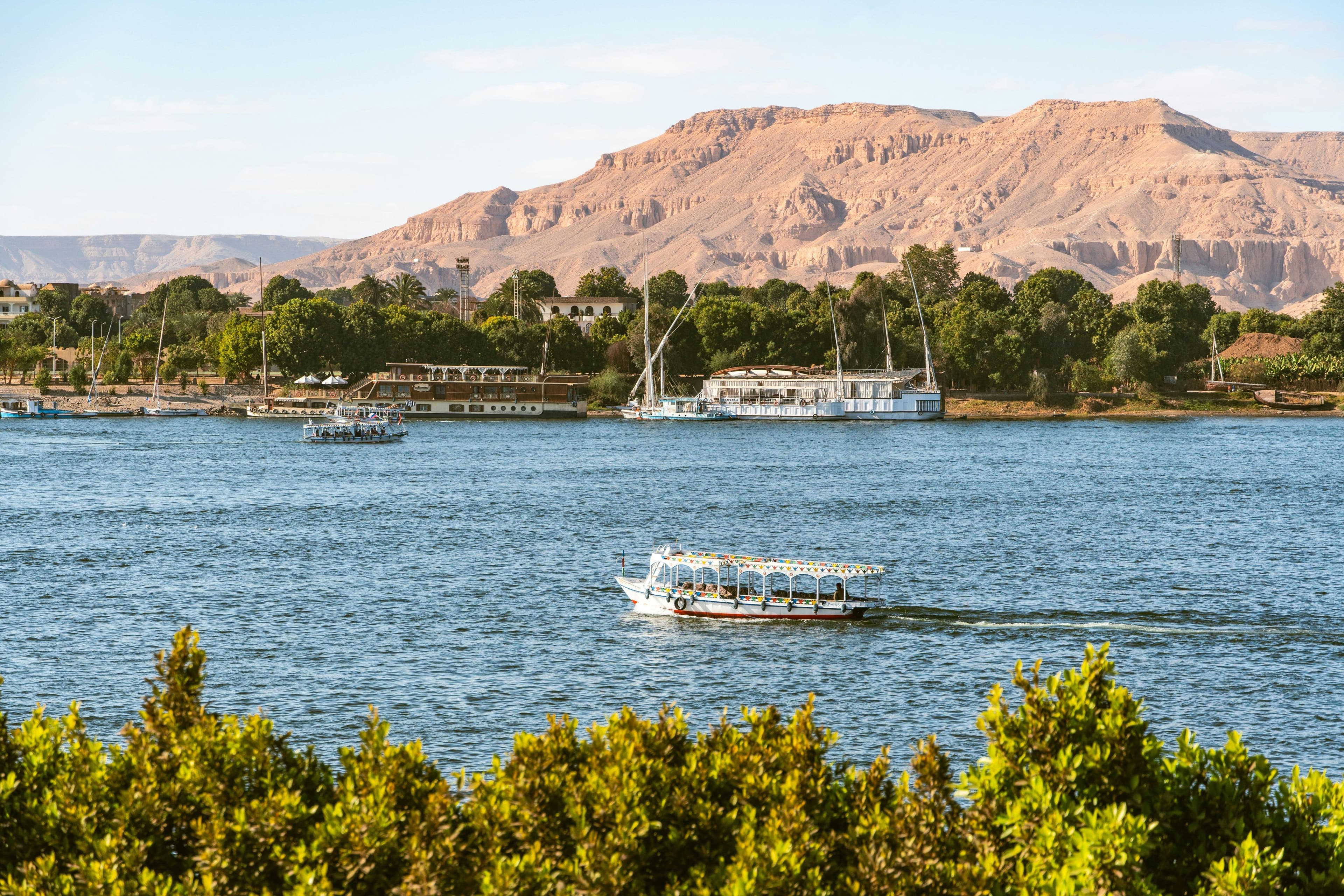 The Nile boats moored beneath the Theban hills.