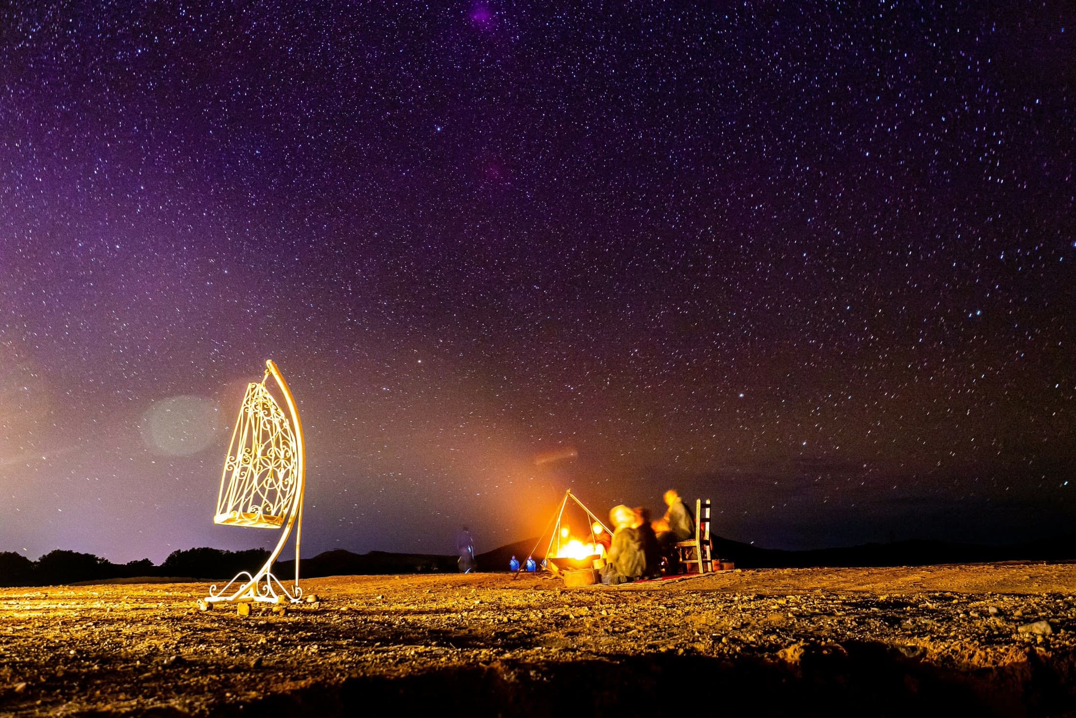 A fire in the sand, and the night coming down.
